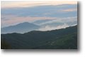 Foto Savignone - Panorami - La frazione Gualdrà e il Santuario della Guaria tra le nebbie al tramonto. Da Montemaggio (Chiappazza)